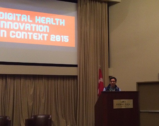 Photo: Bert Navarrete introduces the Digital Health Innovation in Context conference. Photo Credit: Esther Surden