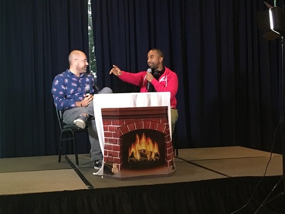 Photo: The "Fireside Chats" with Aaron Price at the NJ Tech Meetup often become animated as founders talk about their passion for their businesses. Here we see Ali Abdullah, CEO of Newark startup ClaimIt!, making a point. We also like the fake cardboard fireplace! Photo Credit: Esther Surden