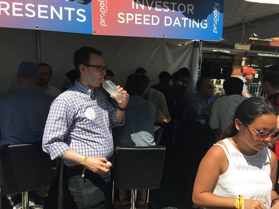 Photo: Crowded Deloitte booth where entrepreneurs and investors met for "speed dating." Photo Credit: Esther Surden
