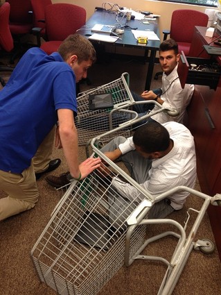 Photo: Putting the nuts and bolts to Cart Magic. RSS interns learning where the rubber meets the road. Photo Credit: Courtesy TechLaunch