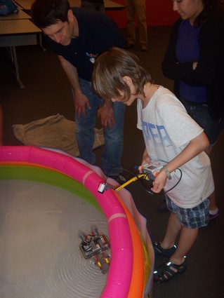 Photo: Students at the Stevens WaterBotics camp test their Lego robot in an inflatable pool. Photo Credit: Alan Skontra