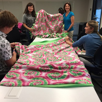 Photo: Employees made blankets for Project Linus. Photo Credit: Courtesy Commvault