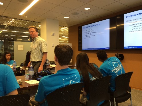 Photo: Students are listening to Gordon Mosely talk about network security. Photo Credit: Esther Surden